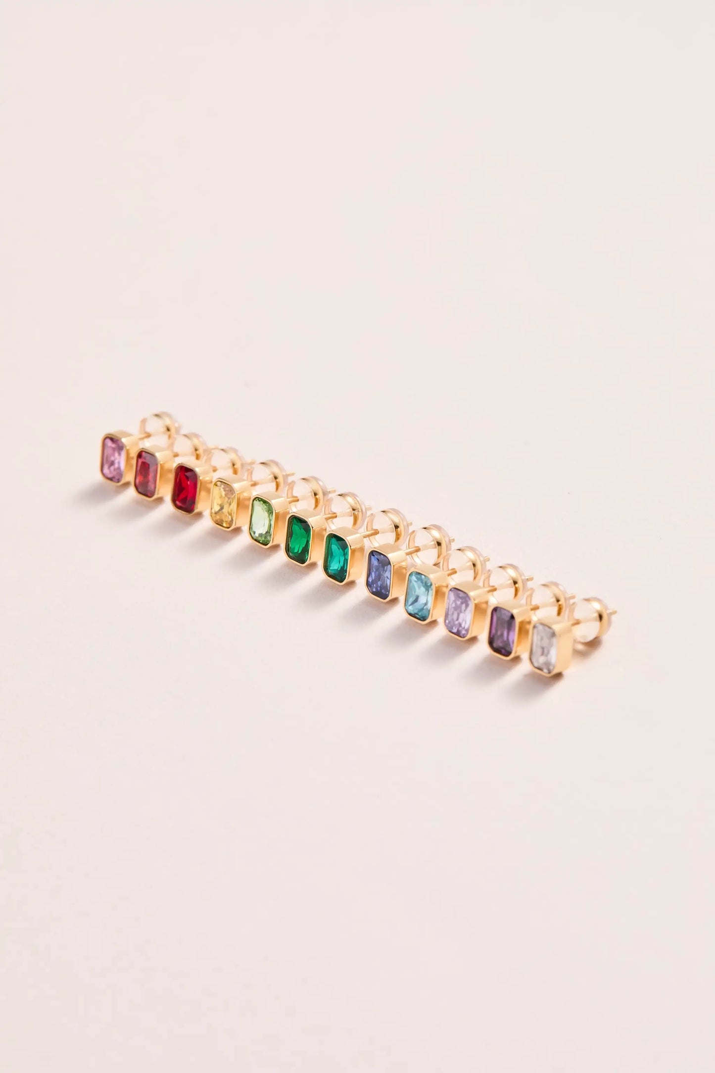 Set of December emerald-cut birthstone stud earrings in gold settings, rainbow stones lined in a row on Tampa Home & Garden Store
