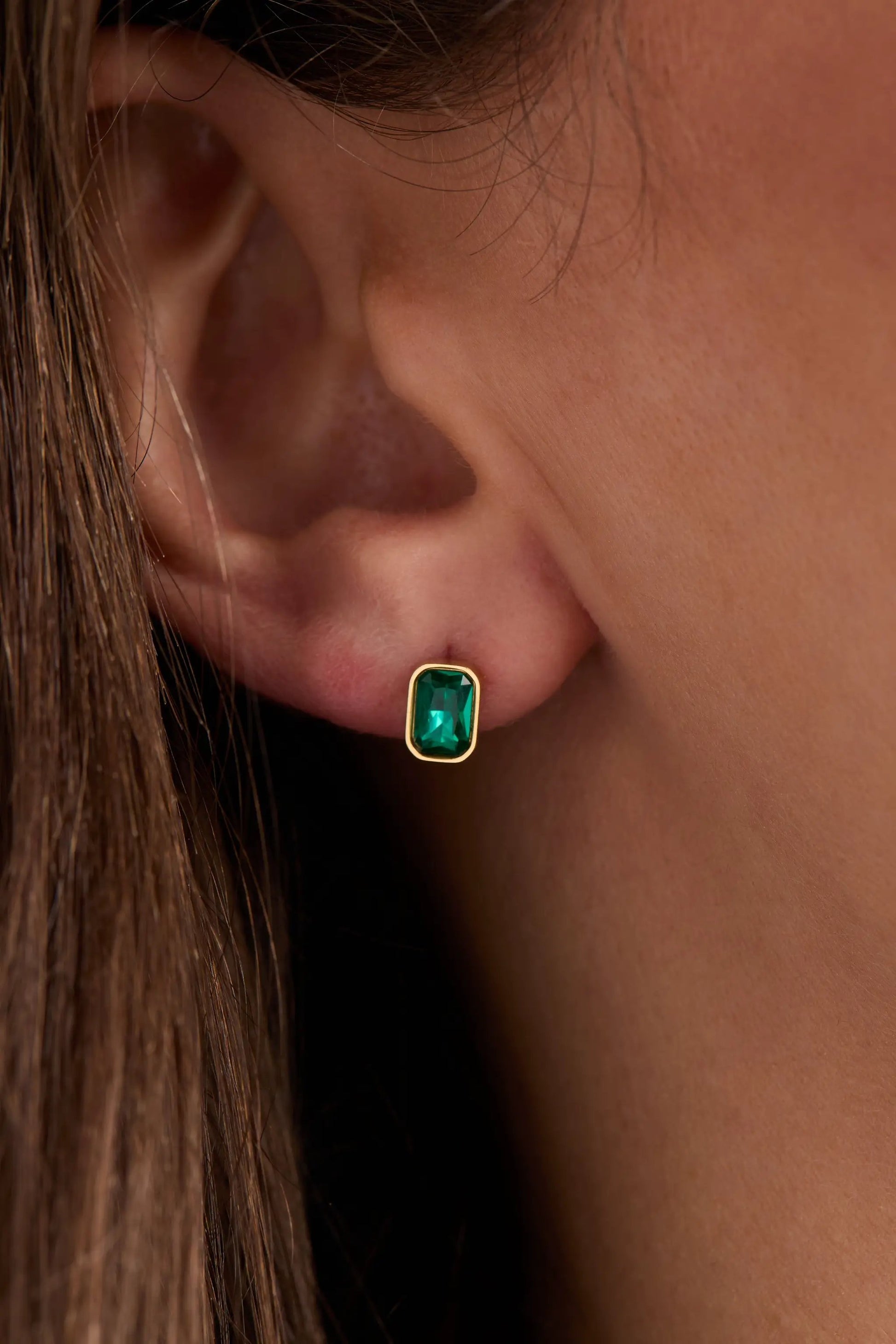 December emerald-cut birthstone stud earrings with a green gemstone set in a gold bezel on Tampa Home & Garden Store