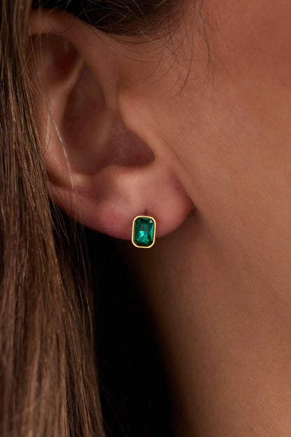 December emerald-cut birthstone stud earrings with a green gemstone set in a gold bezel on Tampa Home & Garden Store