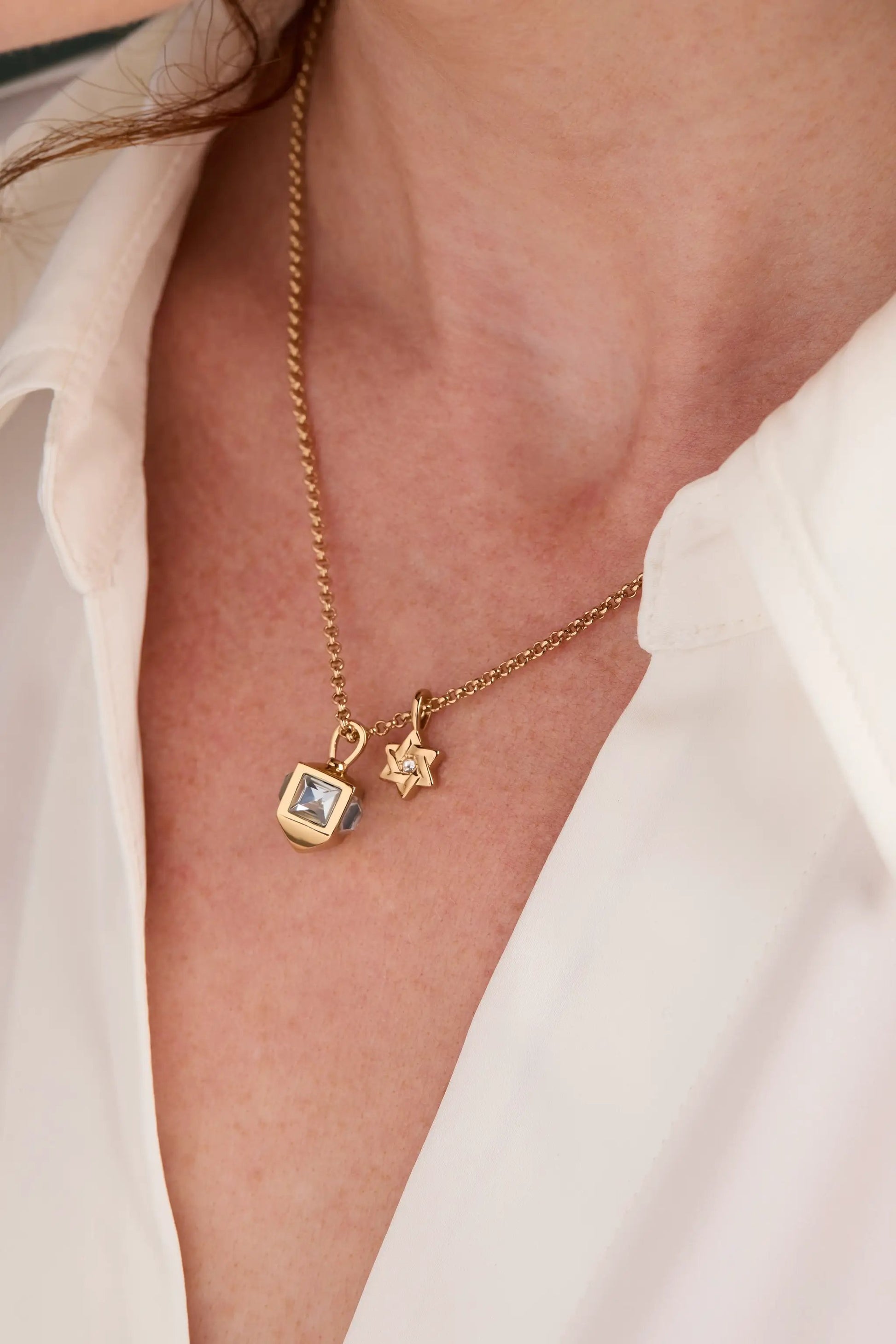 Hanukkah Star of David and Dreidel necklace with gold tone chain and blue gemstone pendant on Tampa Home & Garden Store