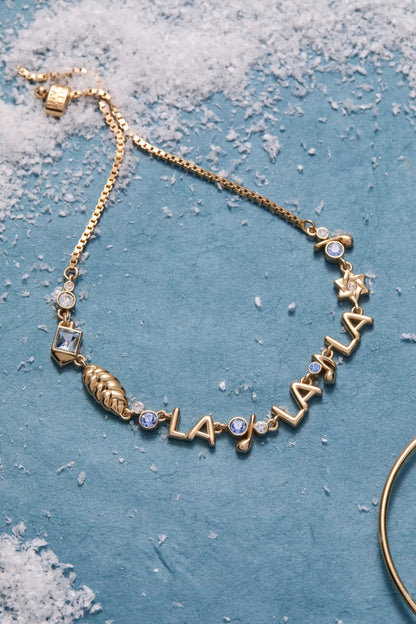 Gold-tone ALEX AND ANI Challah-la-la-la bolo bracelet with blue crystal accents and star charms on Tampa Home & Garden Store