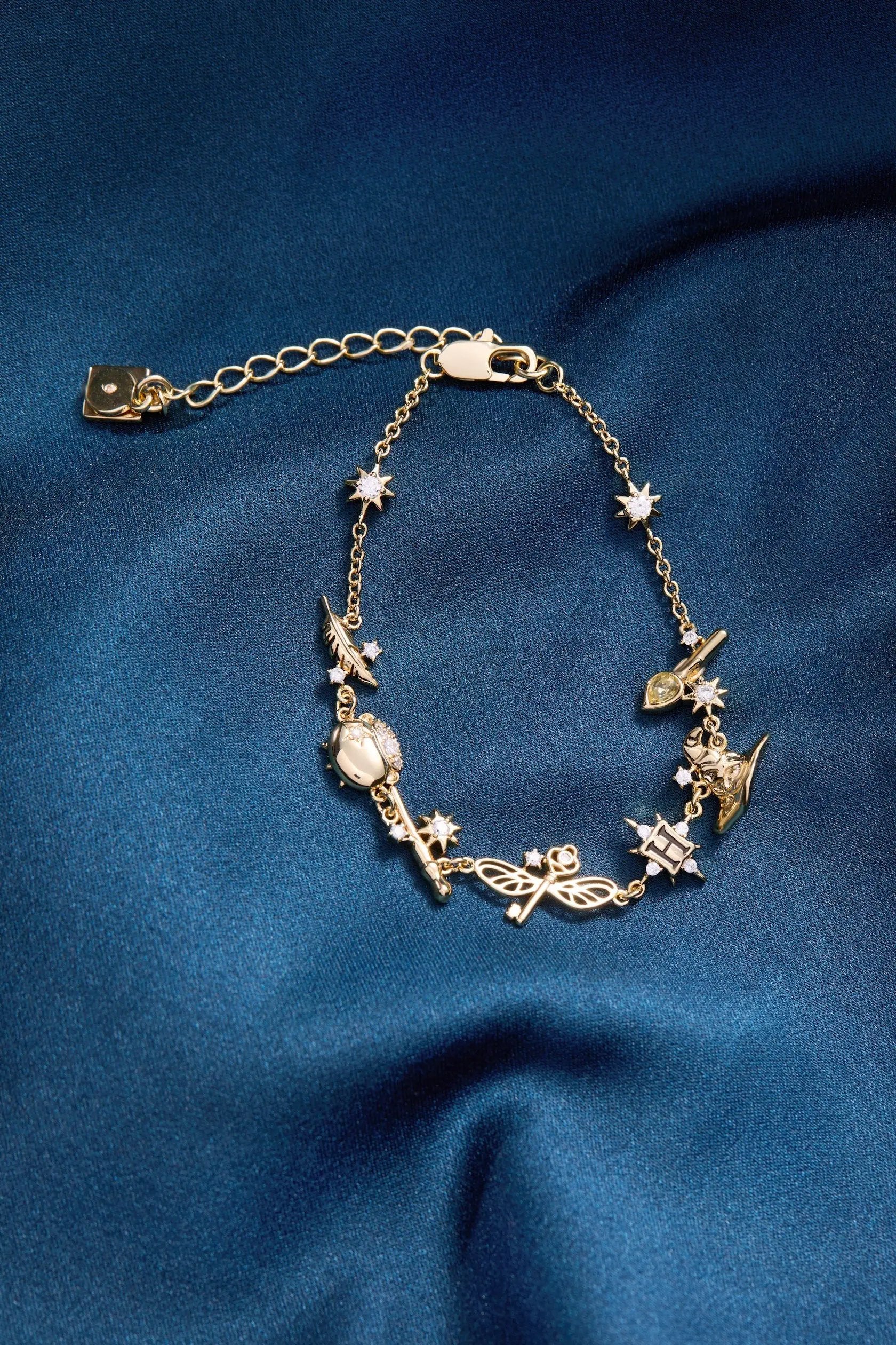 Harry Potter™ Mixed Icon Inline Charm Bracelet with gold-tone chain and crystal accents on Tampa Home & Garden Store