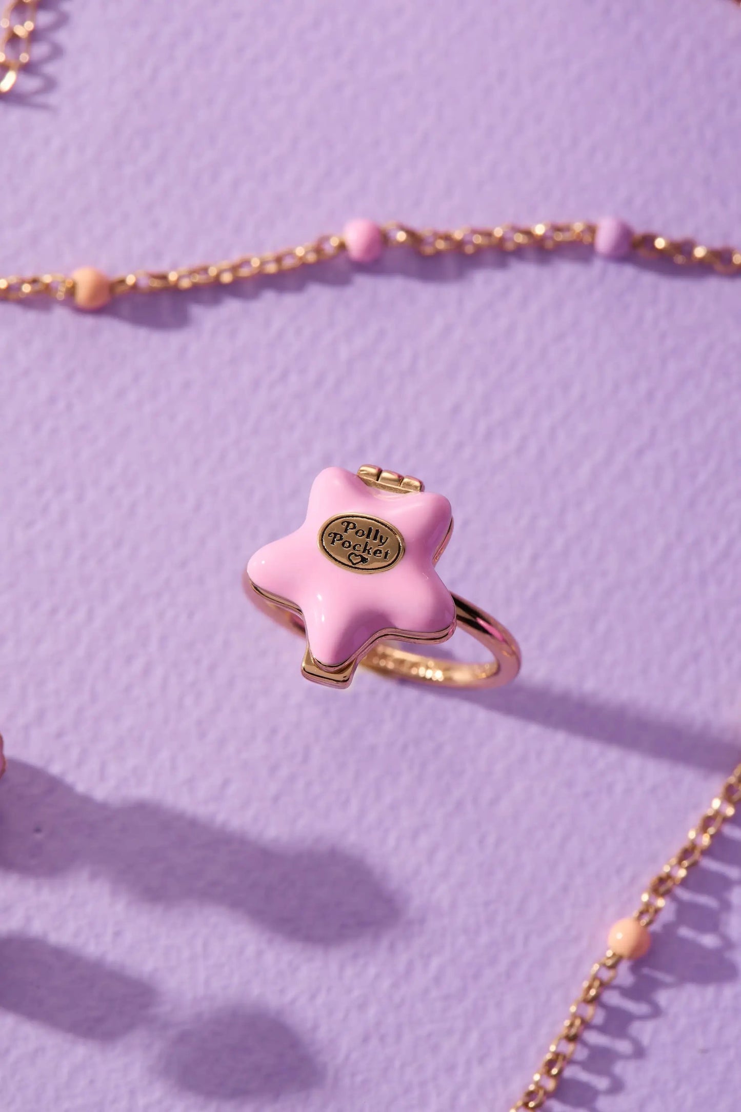 Polly Pocket locket pink star enamel with gold-tone setting and chain on lavender surface on Tampa Home & Garden Store