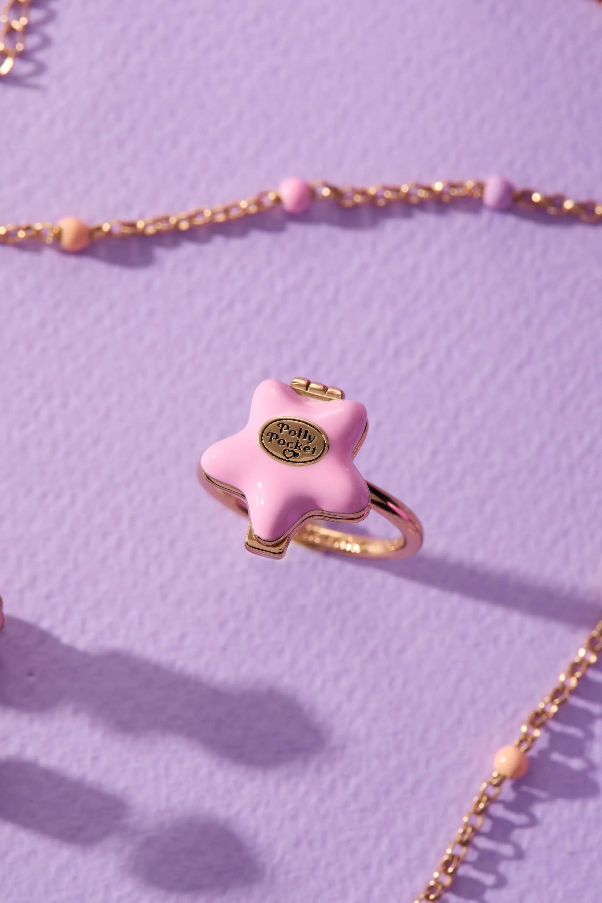 Polly Pocket locket pink star enamel with gold-tone setting and chain on lavender surface on Tampa Home & Garden Store