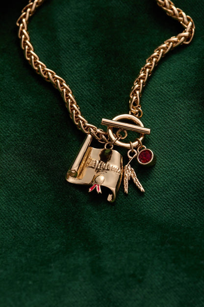 The Wizard of Oz™ Scarecrow Toggle Bracelet gold chain with toggle clasp and red gemstone charm on Tampa Home & Garden Store