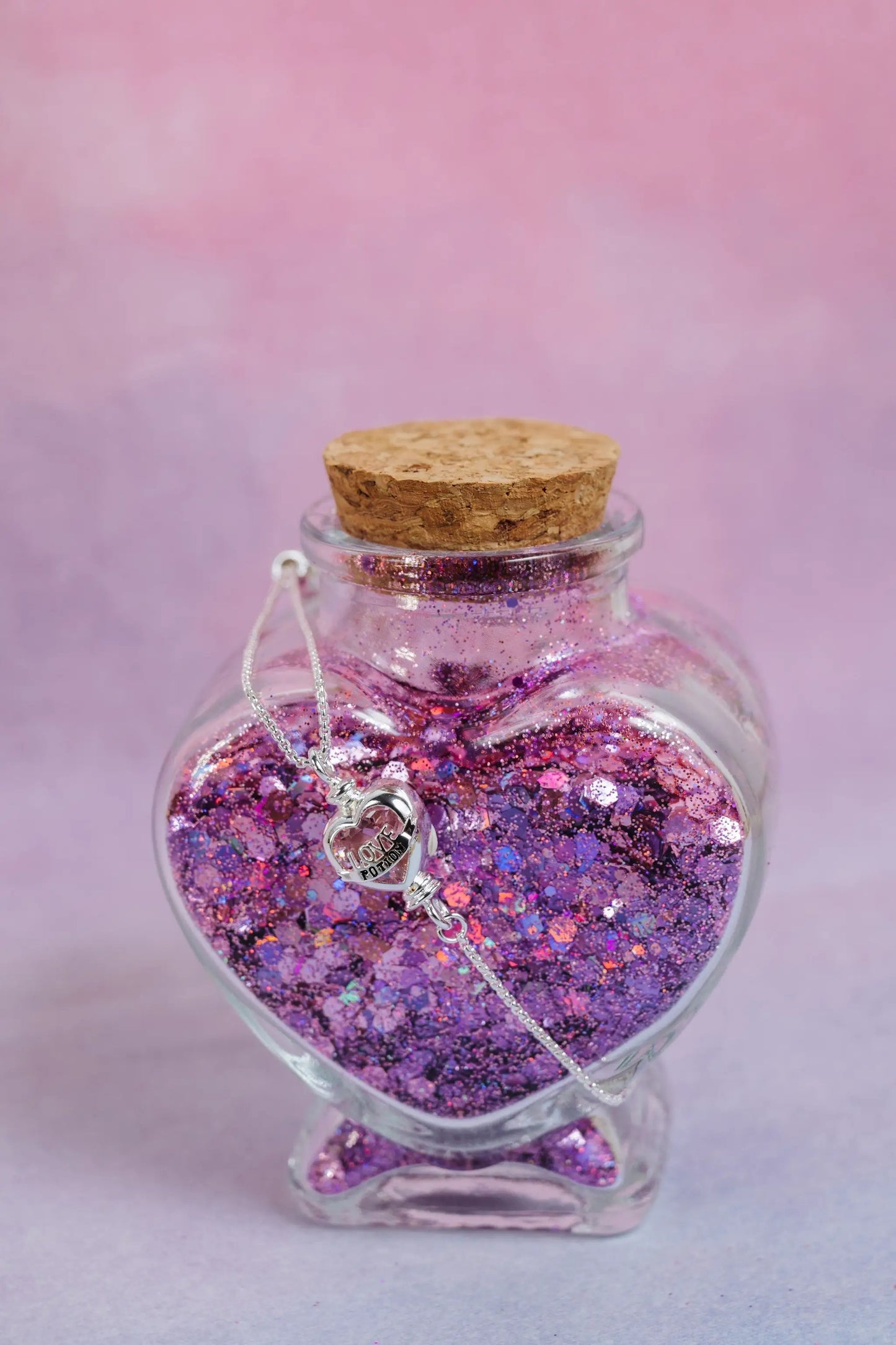 Harry Potter Love Potion bracelet with pink glitter bottle pendant and silver heart charm on Tampa Home & Garden Store