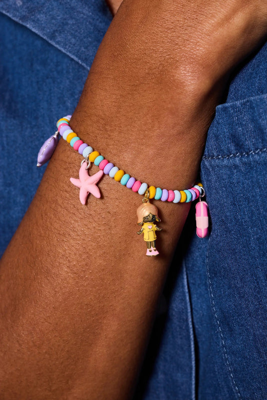 Polly Pocket Pool Party Stretch Charm Bracelet; pastel bead bracelet with starfish charm on wrist on Tampa Home & Garden Store