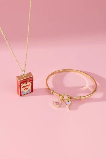Sweethearts Box Locket Necklace on a gold chain beside a gold charm bracelet with soul mate heart and key charms on Tampa Home & Garden Store