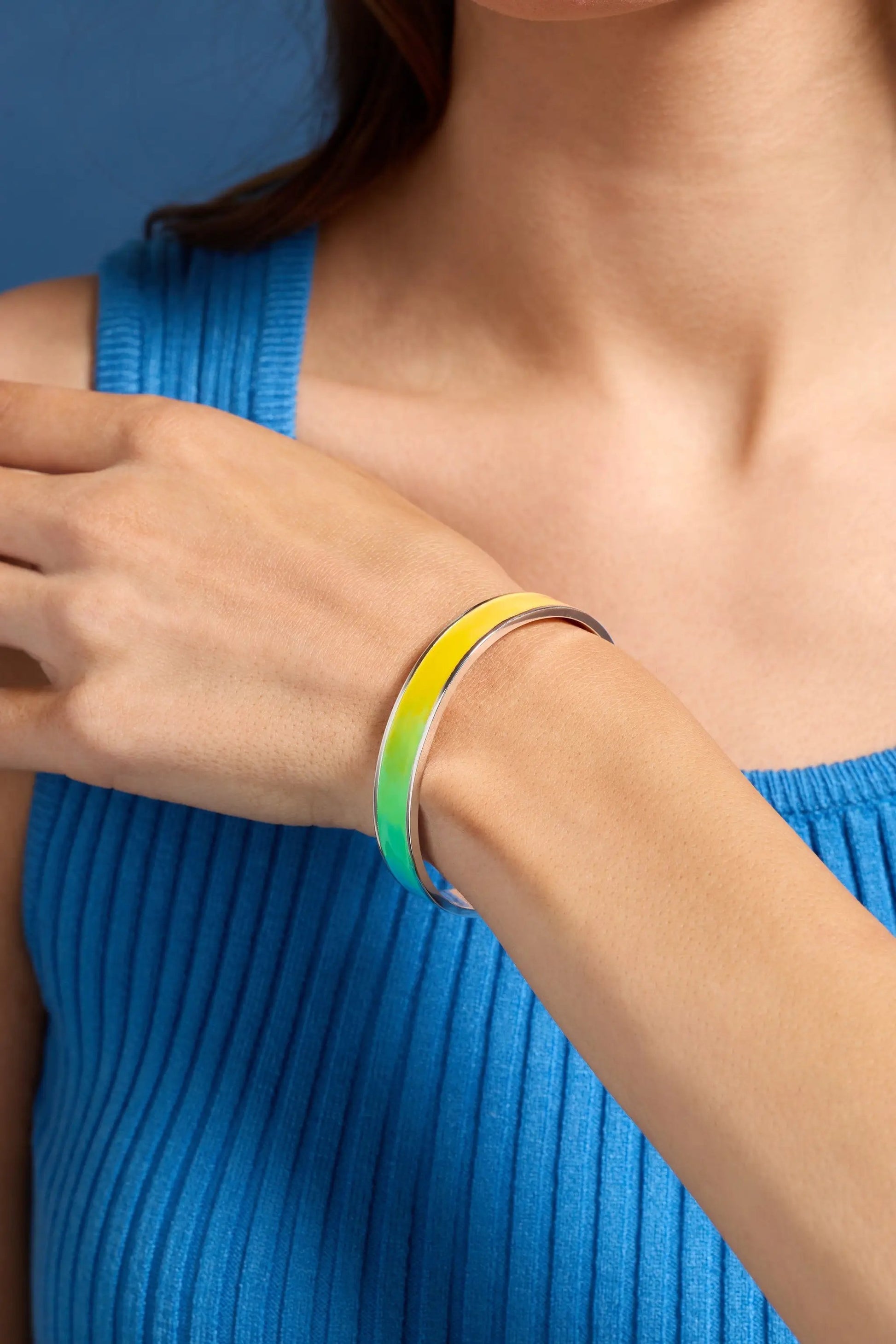 Crayola Rainbow Gradient Cuff bracelet in yellow-green enamel with a silver edge on wrist on Tampa Home & Garden Store
