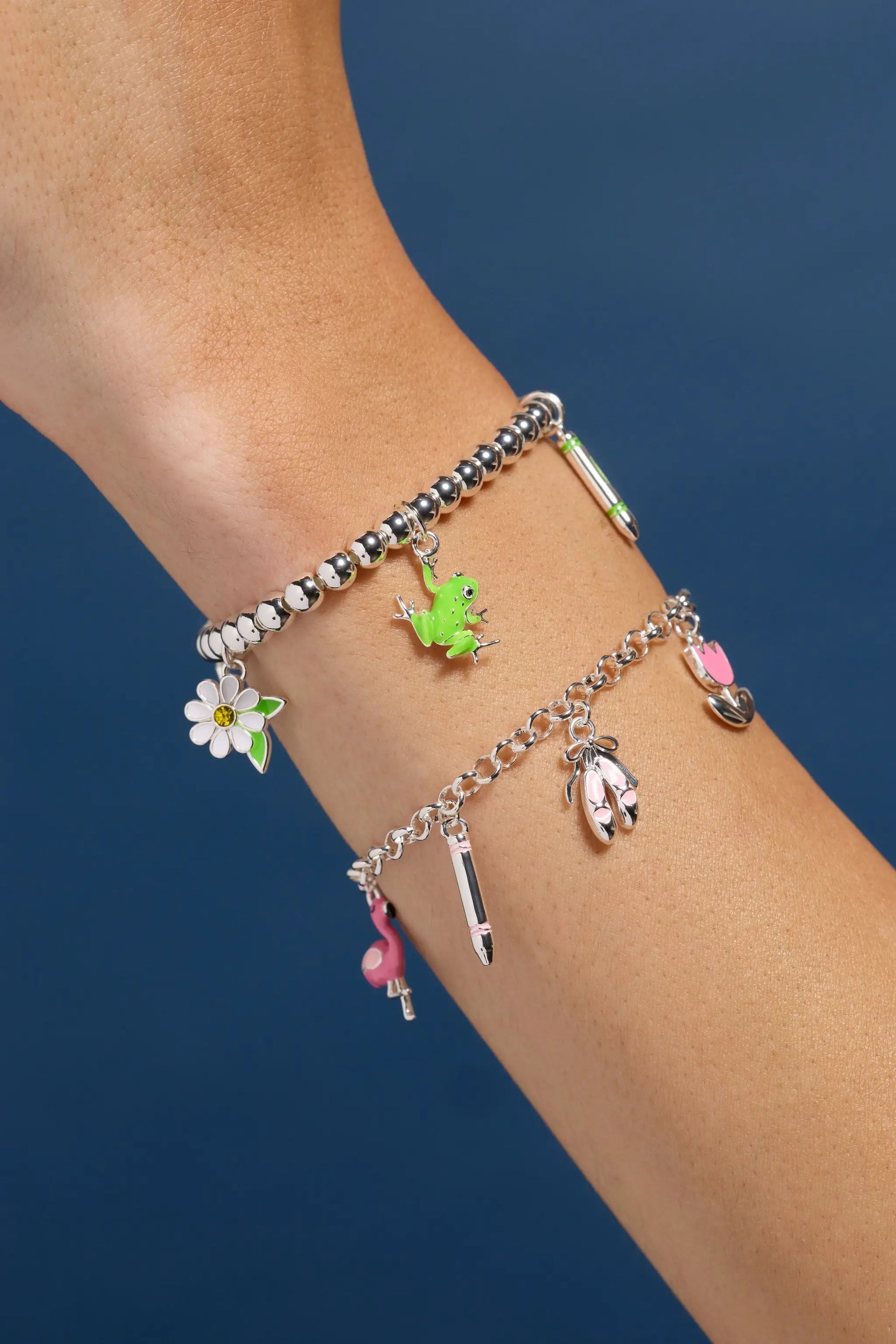 Crayola Forest Green Charm Stretch Bracelets with frog and daisy charms, beads on wrist on Tampa Home & Garden Store