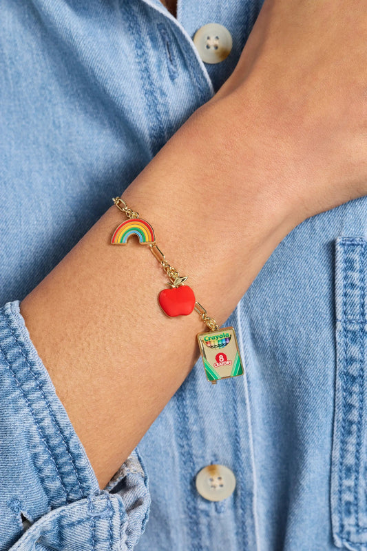 Toggle bracelet with rainbow arc charm, red apple charm, Crayola tag on a gold-tone chain on Tampa Home & Garden Store