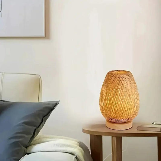 Retro Bamboo LED Desk Lamp With Woven Shade on a round wooden bedside table beside a bed on Tampa Home & Garden Store