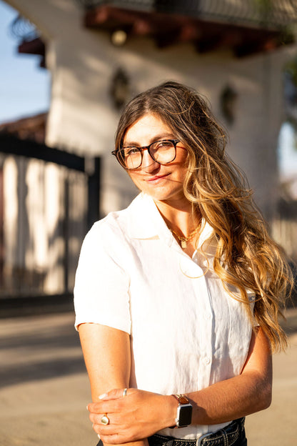 MICHELLE Linen Shirt white linen top by BellEq™ Equestrian Apparel worn by a woman outdoors on Tampa Home & Garden Store