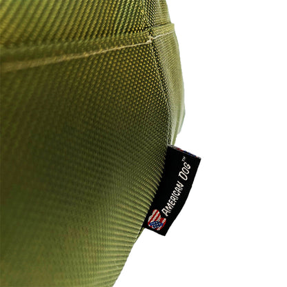 Round bolstered dog bed in olive green textured fabric with brand tag American Dog on Tampa Home & Garden Store