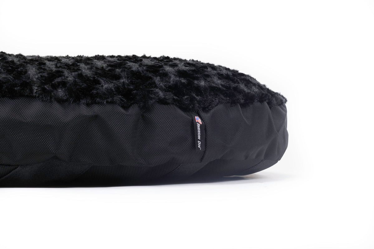 Dog Bed Round Furvana™ by American Dog with black faux fur top and quilted black fabric base on Tampa Home & Garden Store