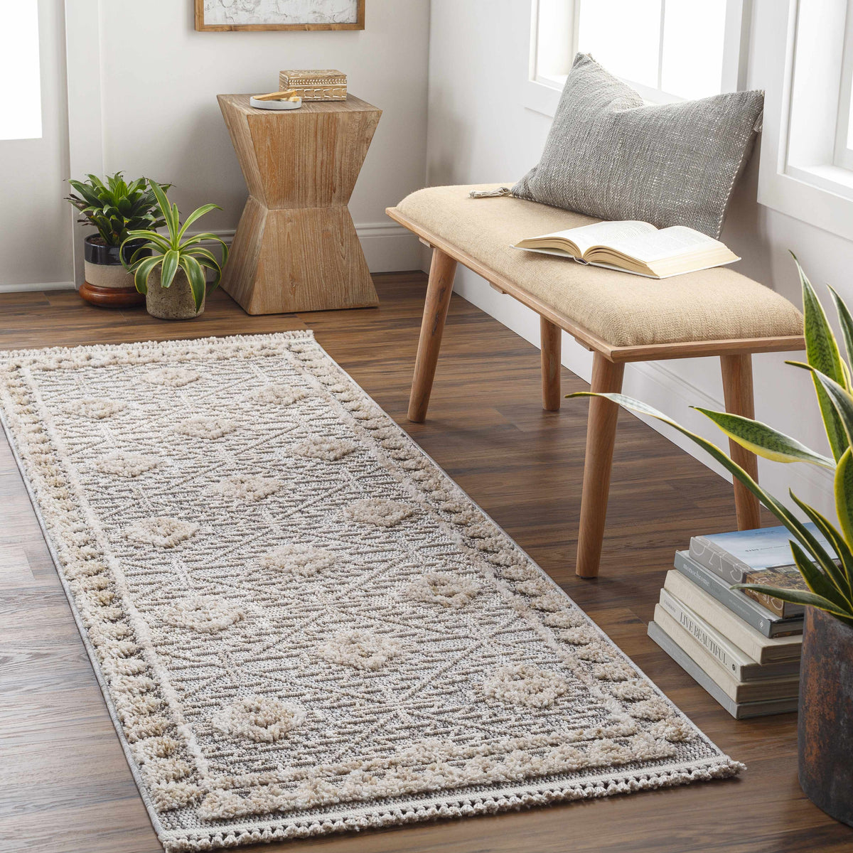 Agoo high-low pile rustic beige rug in a cozy seating area with wood bench and gray cushion on Tampa Home & Garden Store