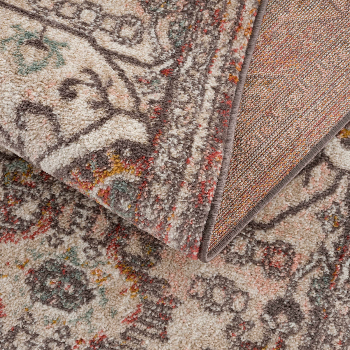 Yennora area rug by Boutique Rugs, beige base with teal and red accents, bound edge on Tampa Home & Garden Store