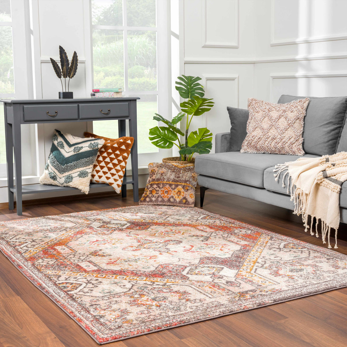 Yennora Area Rug by Boutique Rugs, gray base with orange accents in pattern in living room on Tampa Home & Garden Store