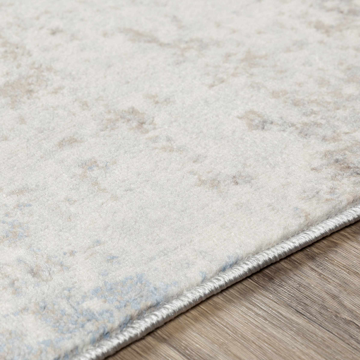 Alcove Abstract Area Rug by Boutique Rugs in cream beige with fringed edge on hardwood floor on Tampa Home & Garden Store