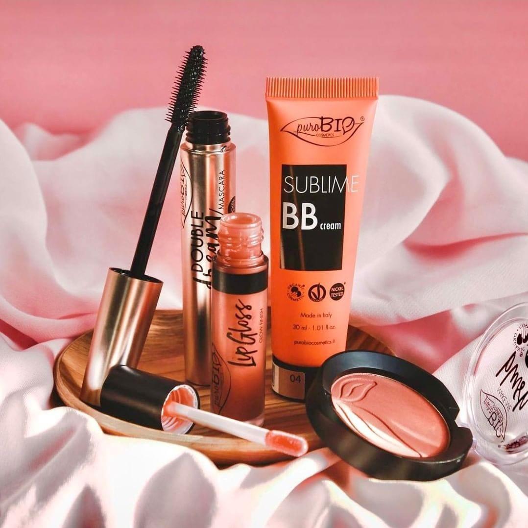 PuroBio Sublime BB cream tube in peach packaging and blush compact on pink satin backdrop on Tampa Home & Garden Store