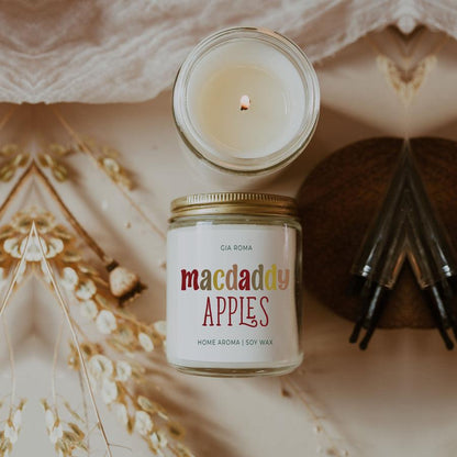 Macdaddy Apples candle by Gia Roma in a glass jar with soy wax and a lit wick on Tampa Home & Garden Store