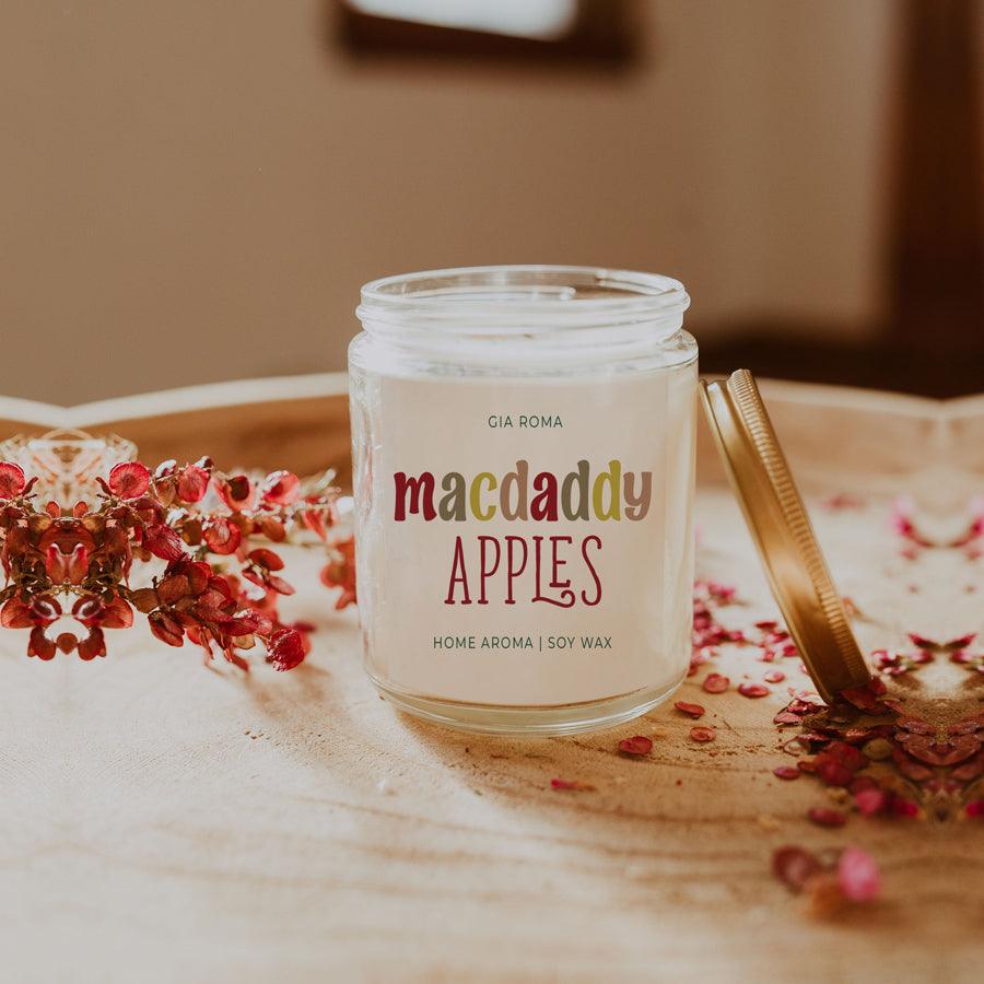 Macdaddy Apples candle in glass jar with lid, Gia Roma label, flowers nearby on Tampa Home & Garden Store