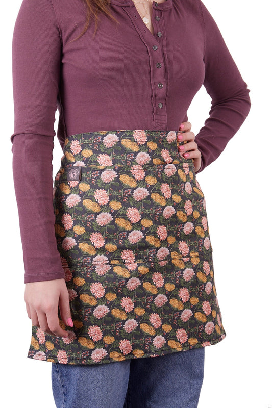 Gardener's Half Apron by Womanswork, floral print with pink and yellow blooms on dark background on Tampa Home & Garden Store