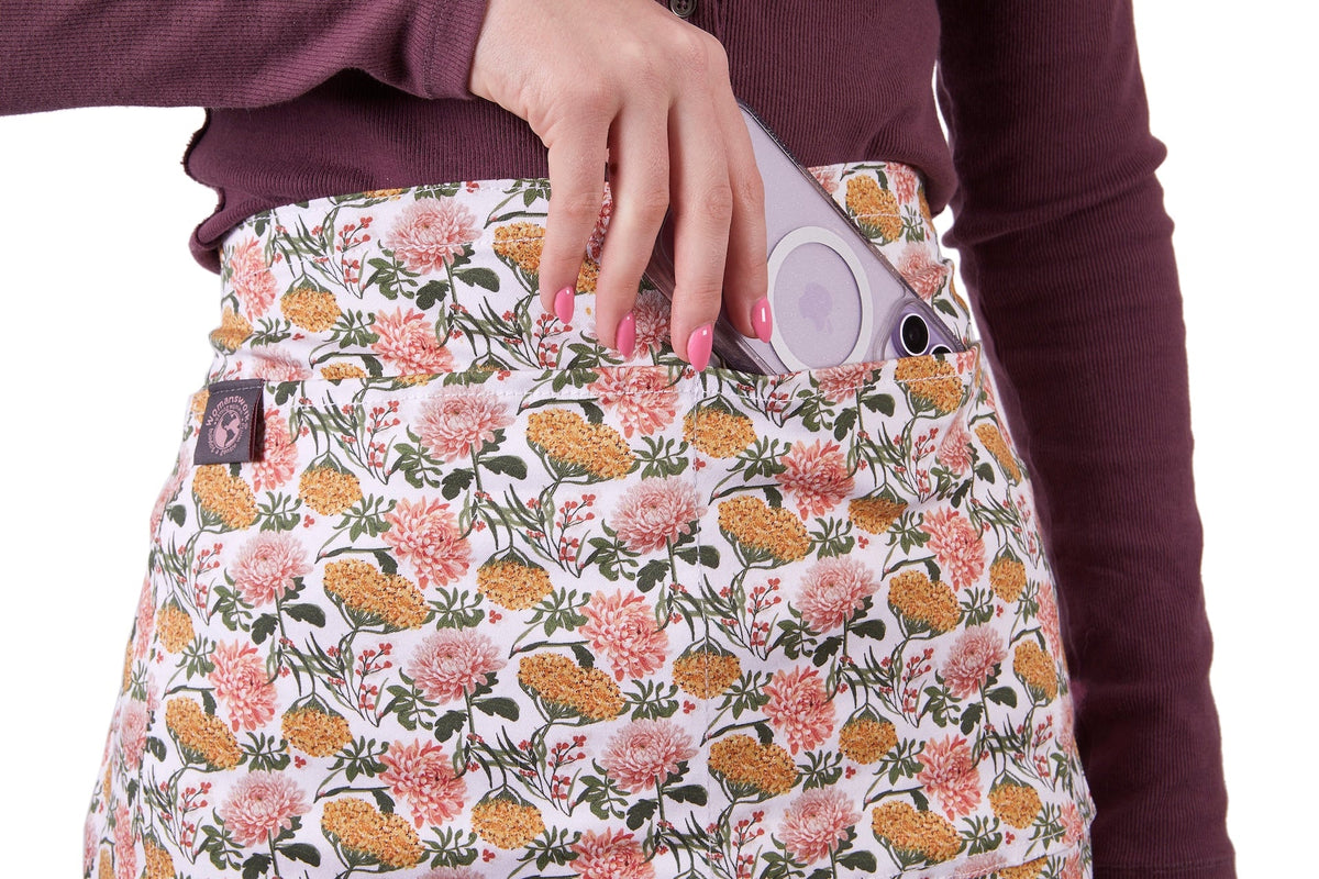 Gardener's Half Apron floral print by Womanswork with pocket and lavender phone tucked in on Tampa Home & Garden Store