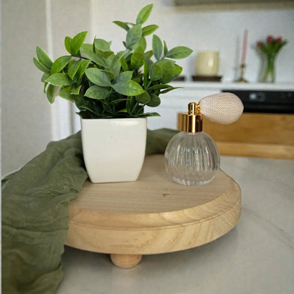 Rustic round wood pedestal jewelry tray with a potted plant and perfume bottle on Tampa Home & Garden Store