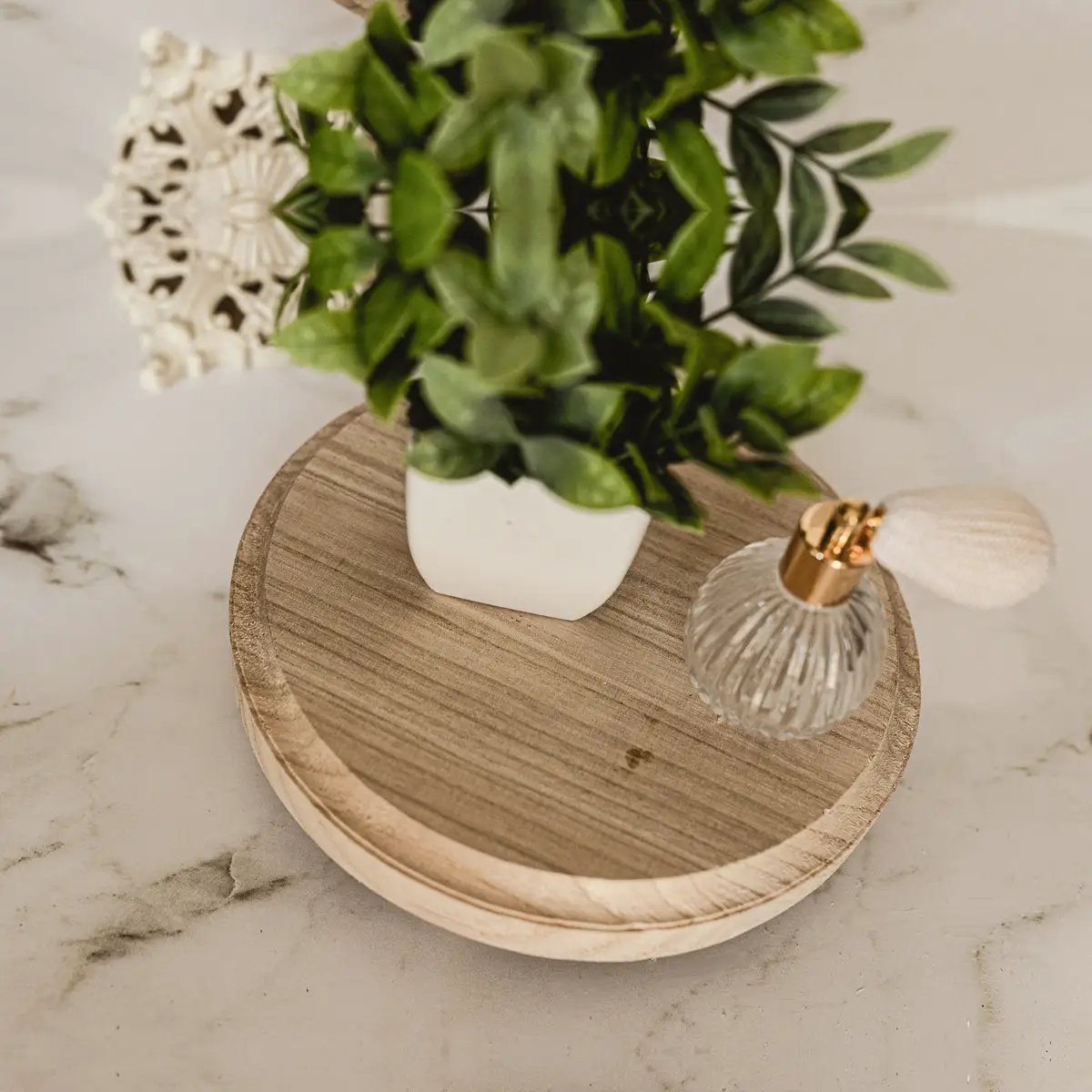 Rustic round wood jewelry tray on pedestal Gia Roma with plant and glass bottle on marble on Tampa Home & Garden Store
