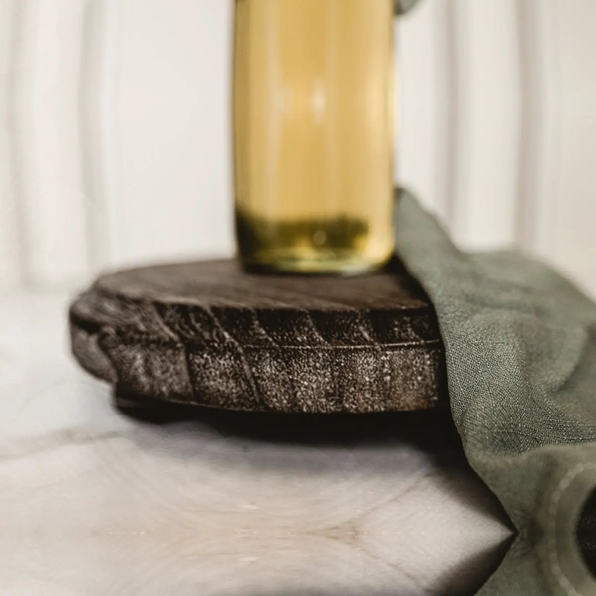 Rustic round wood jewelry tray on pedestal with dark finish and a gold-toned bottle accent on Tampa Home & Garden Store