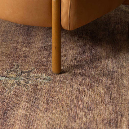 Powhatan washable area rug, brown textured pattern under a wooden chair leg on Tampa Home & Garden Store