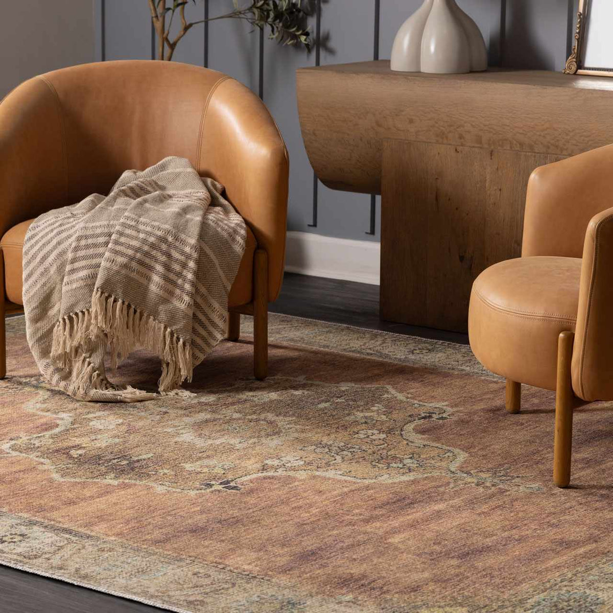 Powhatan washable area rug by Boutique Rugs in rust with a vintage border in a living room on Tampa Home & Garden Store