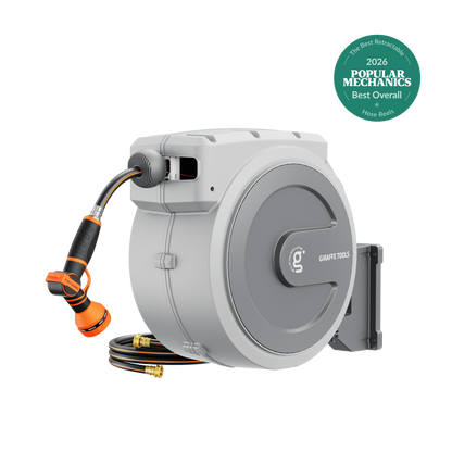 Retractable garden hose reel by Giraffe Tools, gray wall-mount housing with orange hose and nozzle on Tampa Home & Garden Store