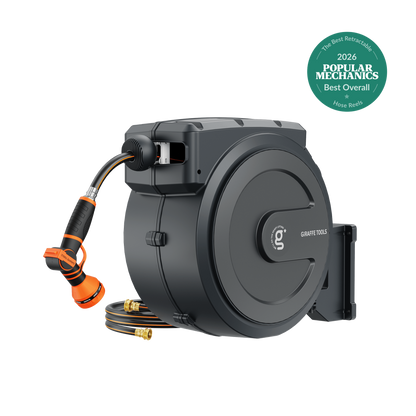 Retractable garden hose reel by Giraffe Tools in dark gray with orange hose and auto rewind on Tampa Home & Garden Store