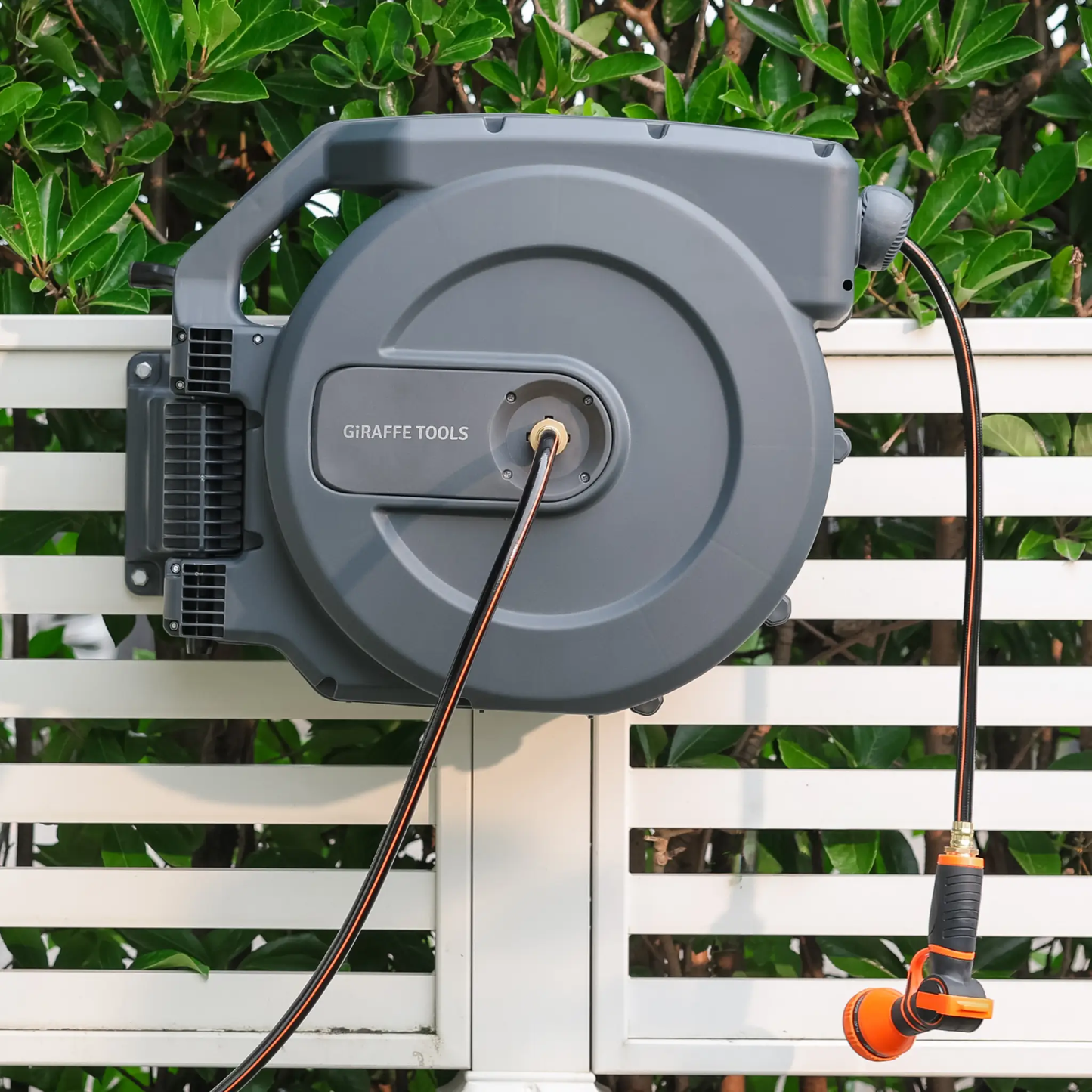 Retractable Garden Hose Reel by Giraffe Tools; gray housing with orange and black hose on Tampa Home & Garden Store