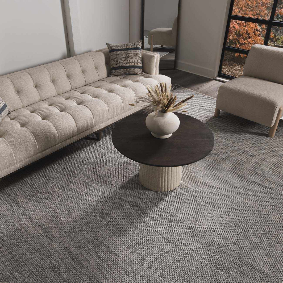 Stenhousemuir Luxe Handmade Rug beige woven area rug in a modern living room by Boutique Rugs on Tampa Home & Garden Store