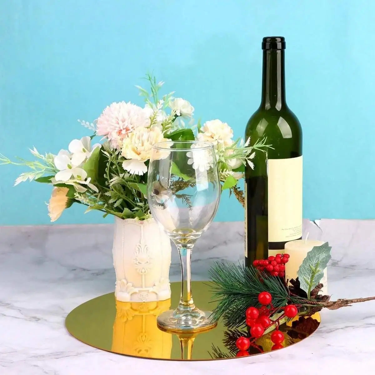 Clear acrylic centerpiece set on a round gold mirror tray with floral arrangement and wine decor on Tampa Home & Garden Store