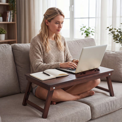 Adjustable bamboo laptop desk with tilting top on a sofa, with laptop and notebook on Tampa Home & Garden Store