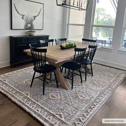 Agoo High-Low Pile Rustic Rug with geometric pattern under a dining table and black chairs on Tampa Home & Garden Store