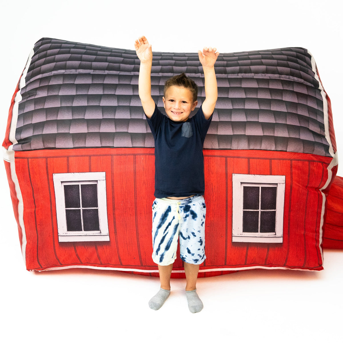 AirFort Farmers Barn inflatable play fort, red barn exterior with windows, kid inside on Tampa Home & Garden Store