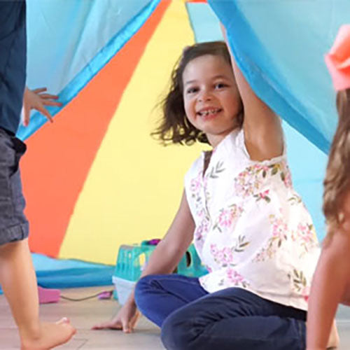 AirFort Beach Ball blue inflatable play fort for kids, girl inside colorful fort on Tampa Home & Garden Store