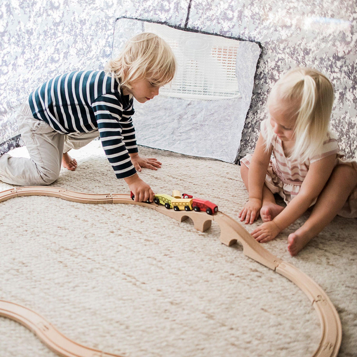 AirFort Digital Camo Inflatable Play Tent for Kids AirFort.com with wooden train set on carpet on Tampa Home & Garden Store