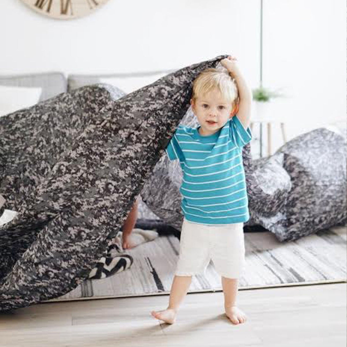 AirFort digital camo inflatable play tent for kids, child lifting camouflage fabric indoors on Tampa Home & Garden Store
