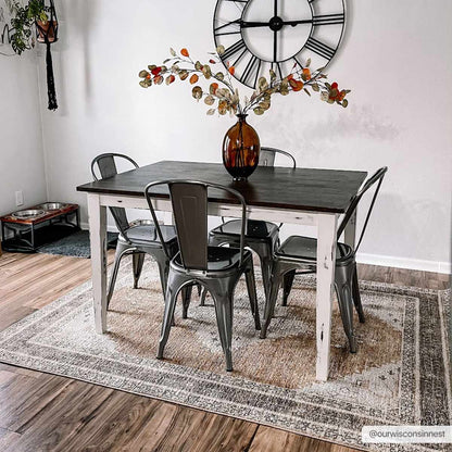 Albas Washable Area Rug by Boutique Rugs under a rustic white dining table with metal chairs on Tampa Home & Garden Store
