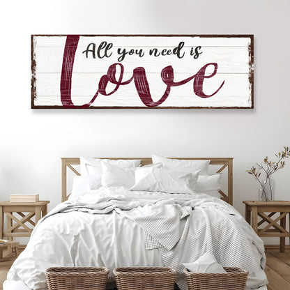 All You Need Is Love canvas sign on rustic whitewashed wood with burgundy script above a bed on Tampa Home & Garden Store