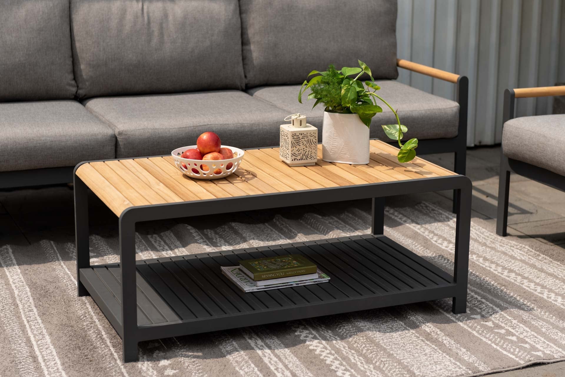 Amber teak and aluminum rectangular coffee table with wood slat top and black frame on Tampa Home & Garden Store