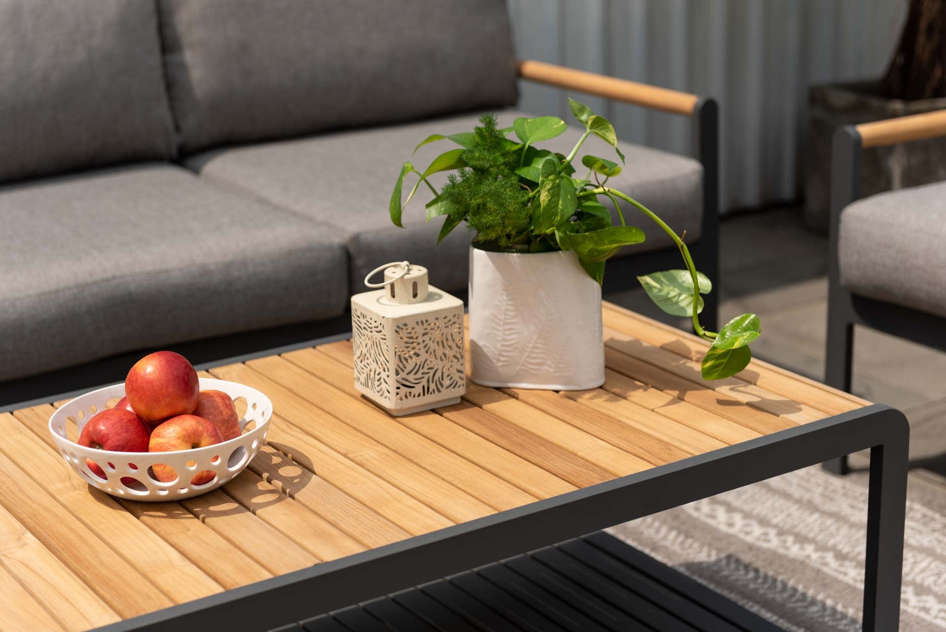 Amber Teak and Aluminum Rectangular Coffee Table with teak top and aluminum frame outdoors on Tampa Home & Garden Store
