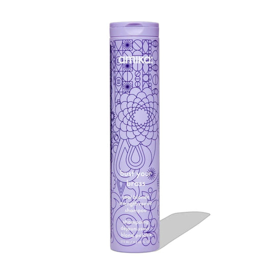 Amika Bust Your Brass Cool Blonde Repair Shampoo bottle, purple with geometric line-art pattern on Tampa Home & Garden Store