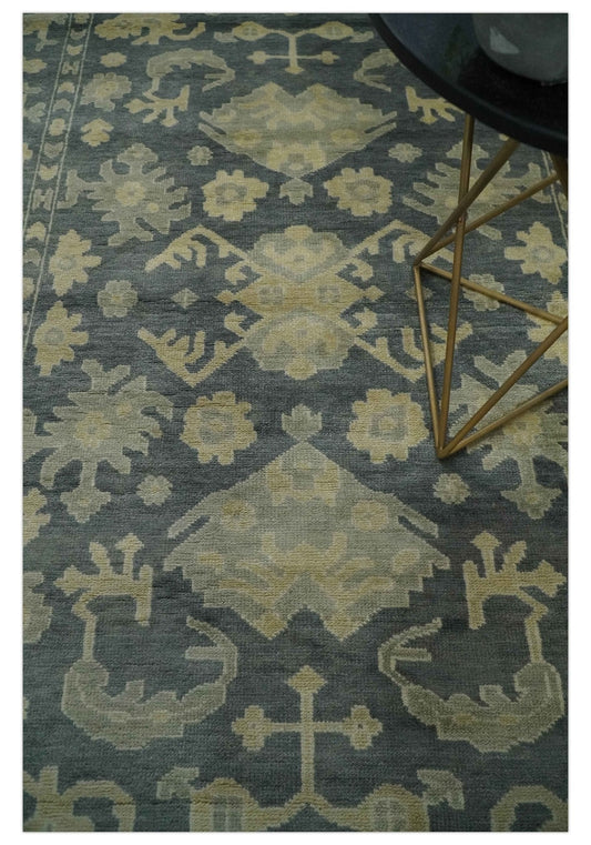 Antique-style hand-knotted wool area rug beige and charcoal with a floral medallion pattern on Tampa Home & Garden Store